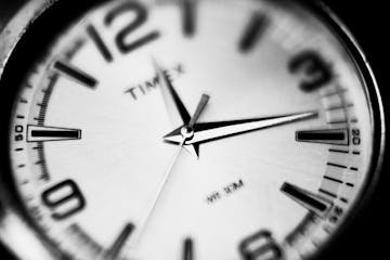 Detailed black and white close-up of a Timex analog watch displaying precision and timekeeping.